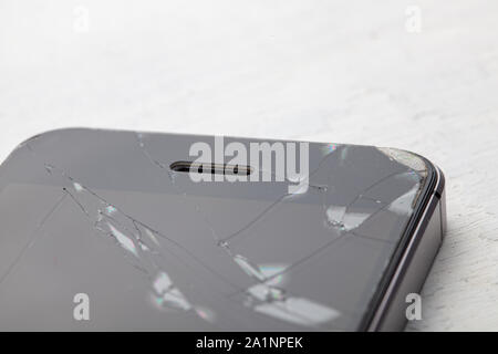 Broken glass phone. Cracks on the display of a mobile phone. Stock Photo
