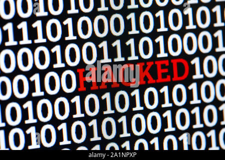Red inscription HACKED in binary code of ones and zeros. Cyber attack electronic devices Stock Photo