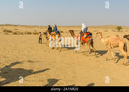 Jaisalmer, India - February 14, 2019: Tourists on Camel Safari in Thar desert