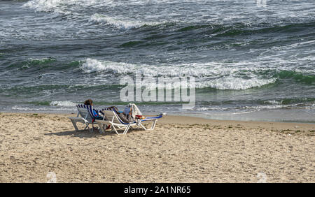 Odessa, Ukraine - 09.05.2019. Romantic couple on the shore on the background of the stormy sea in the resort of Arcadia in Odessa Stock Photo