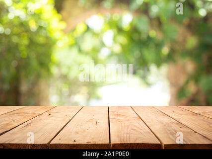 Empty wood table top on blur abstract green from garden and home area background.For montage product display or design key visual layout Stock Photo