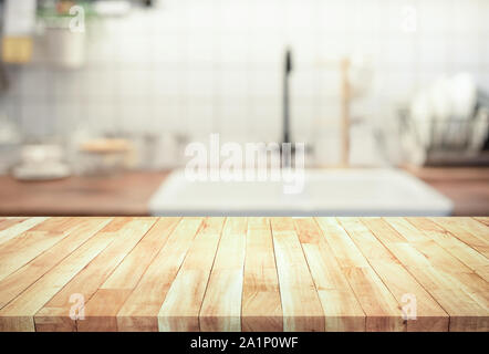 Wood table top on blur kitchen counter (room)background.For montage product display or design key visual layout. Stock Photo