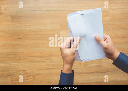 Male holding paper envelope, letter on floor wood. business concepts ideas Stock Photo