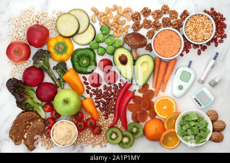 Low glycemic food for diabetics with blood sugar testing kit & pedometer. Health food below 55 on the GI index. Flat lay. Stock Photo