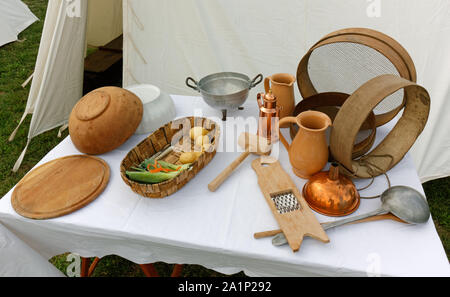 Various vintage utensils on a table during a historical reenactment Stock Photo