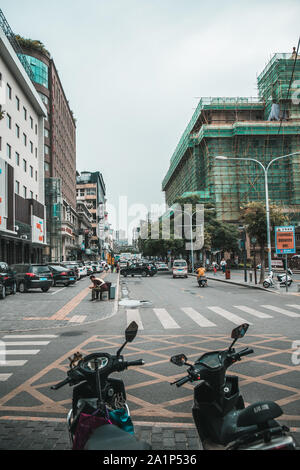 Xian, China -  July 2019 : Scooters parked on a street in the city of Xian in summer, Shaanxi Province Stock Photo