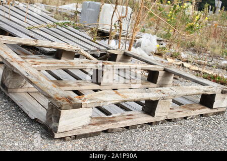 Details, manufactured wooden pallets. Waste abandoned on the ground Stock Photo