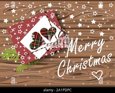 Festive Merry Christmas card with gift box on wooden table and greeting lettering. Vector flat lay top view Stock Vector