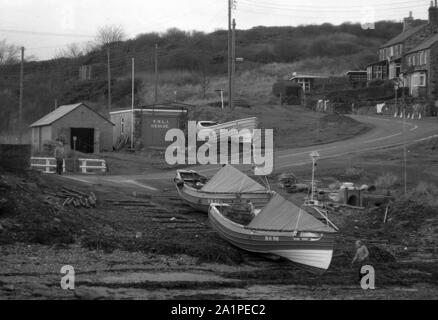 Fishing Cobles being hauled on to beach, Craster, Northumberland, c.1973 Stock Photo