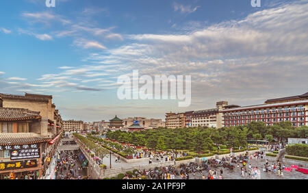 Xian, China -  July 2019 : Crowds walking on streets and town square with landmark Drum Tower in the background, Shaaxi Province Stock Photo