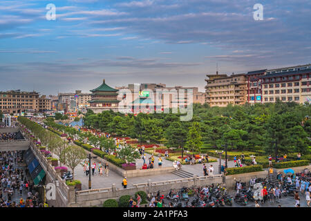 Xian, China -  July 2019 : Crowds walking on streets and town square with landmark Drum Tower in the background, Shaaxi Province Stock Photo