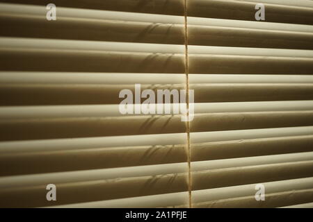 white closed horizontal jalousie with rope close up Stock Photo