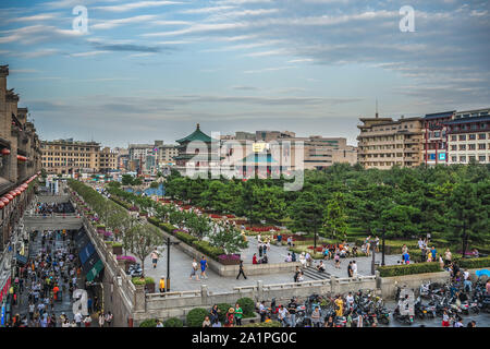 Xian, China -  July 2019 : Crowds walking on streets and town square with landmark Drum Tower in the background, Shaaxi Province Stock Photo