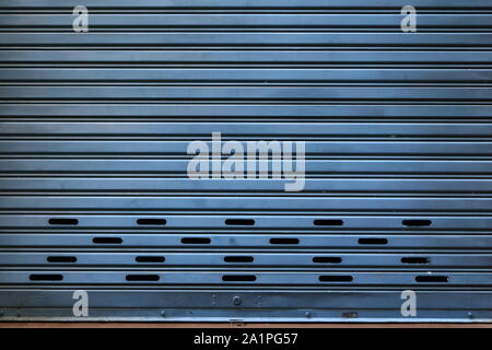 Closeup old steel rolling shutter of a building under sunlight, shutdown concept Stock Photo