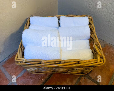 Towels lined up  in a basket and stacked for the walk to the toilet, then handwashed Stock Photo
