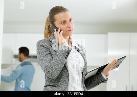 realtor calling someone with her mobile phone Stock Photo