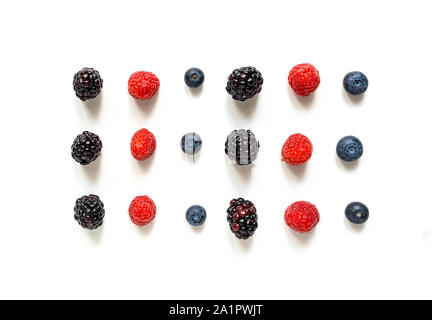 Rows of berries disposed in a geometric way on a minimal space. Isolated on a white background. Stock Photo