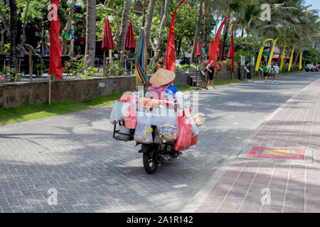 Indonesia Kuta Sept 20 2019, Woman with lots of stuff on scooter in Bali Stock Photo