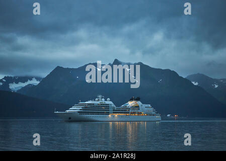 A cruise ship is running at daybreak in the harbor of Seward Stock Photo