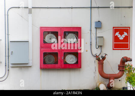 Fire hose with fire extinguisher Was installed outside the building.  High resolution image gallery. Stock Photo