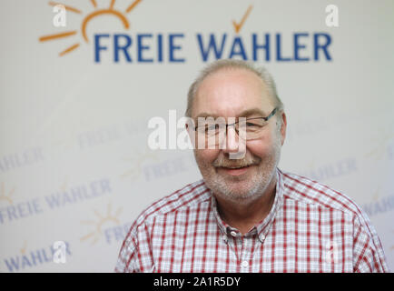 Rostock, Germany. 28th Sep, 2019. Deputy state chairman Klaus Dieter Gabbert (Free Voters of Mecklenburg-Western Pomerania) will stand in front of the party logo in the conference hall of the Trihotel after his election. At the state party conference, the free voters of Mecklenburg-Western Pomerania elected their new executive committee. Credit: Danny Gohlke/dpa/Alamy Live News Stock Photo
