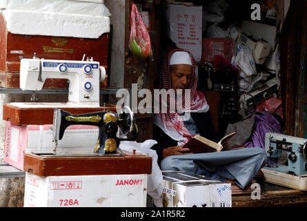 Sanaa, Yemen. 28th Sep, 2019. A man reads a book as he sits inside his shop in Sanaa, Yemen, Sept. 28, 2019. Credit: Mohammed Mohammed/Xinhua/Alamy Live News Stock Photo