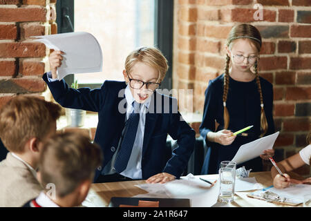 unhappy stict boss holds contract and promisses to lay off workers. close up photo Stock Photo