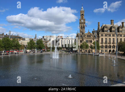 View looking down onto the Mirror Pool with it's fountains running and Centenary Square and Bradford City Hall on the far side of the water, Bradford. Stock Photo