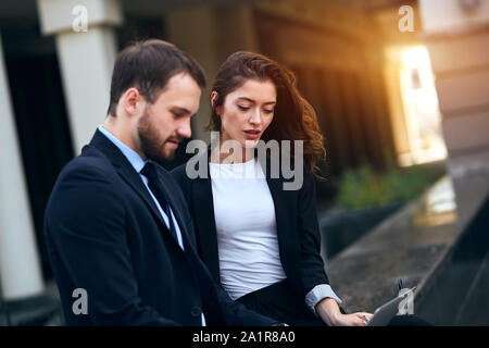 young motivated employees in fashion suits taking part online conference. close up side view photo Stock Photo