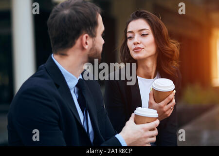 loving romantic couple holding takeaway coffee, enjoying conversation, close up photo. love, friendship Stock Photo