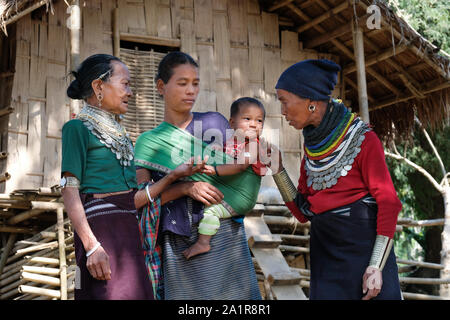 Women of the Reang tribe in front of a traditional house in the village ...