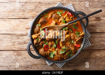 Kashmiri Lamb rogan josh with spices and gravy close-up in a pan on the table. Horizontal top view from above Stock Photo