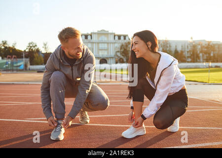 Athletes runners tie shoelaces before training. Stock Photo