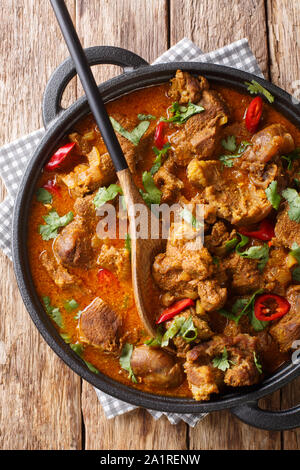 Indian spicy stew Lamb rogan josh closeup in a pan on the table. Vertical top view from above Stock Photo