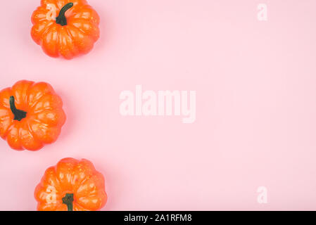 Pink background with three pumpkins. Stock Photo
