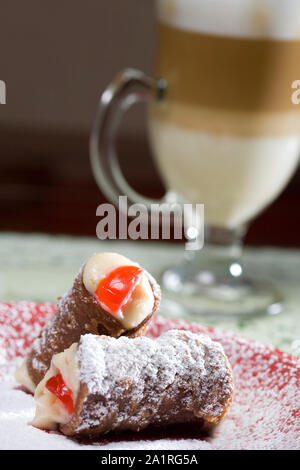 Cannoli dessert typical of Italian cuisine, stuffed with cheese recotes and fruit preserves Stock Photo