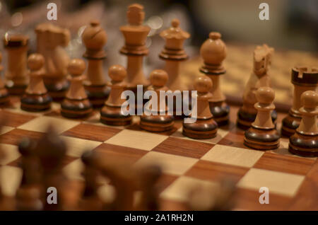Closeup of a wooden Chessboard. Chess is a two player strategy board game played on a checkered board with 64 squares Stock Photo