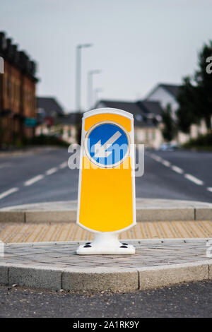 Close up of yellow road crossing sign on pedestrian refuge island in the UK Stock Photo