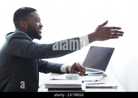 Friendly HR manager extending hand for handshake after successful interview Stock Photo