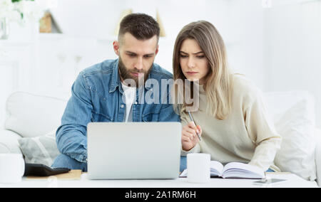 Young couple planning family budget with laptop Stock Photo