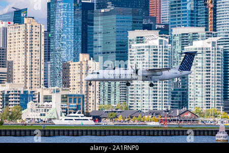 Porter Airlines Bombardier Q400 aircraft on its final approach to Bill Bishop Airport in downtown Toronto Ontario Canada. Stock Photo
