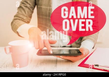 Text sign showing Game Over. Business photo showcasing A situation in a particular sport that reach his finals or ending Business woman sitting with m Stock Photo