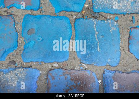 Blue stone texture, vintage paving stones painted blue wet shiny from rain Stock Photo