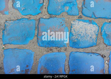 Blue stone texture, vintage paving stones painted blue wet shiny from rain Stock Photo