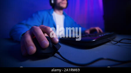 Male hand using computer mouse playing online games Stock Photo