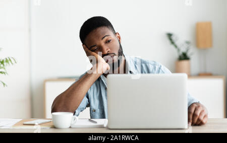 Bored employee sitting in office can not concentrate on work Stock Photo