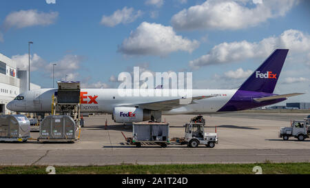 FedEx Boeing 757-2F being loaded with cargo on a sunny day at Toronto Pearson Intl. Airport. Stock Photo
