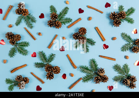 Winter composition. Frame made of fir tree branches, pine, acorn and cinnamon on pastel blue background. Autumn, fall, winter concept. Flat lay, top v Stock Photo