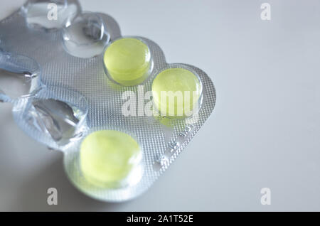 Close up of some medicine tablets/throat lozenges in a blister pack. Copy space for text. Stock Photo