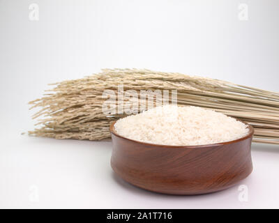 rice seed ,In wooden bowls ,Placed on a white background. Stock Photo